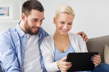 Image showing smiling happy couple with tablet pc at home