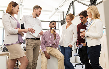 Image showing happy business team drinking coffee at office