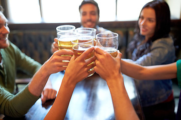 Image showing happy friends drinking beer at bar or pub