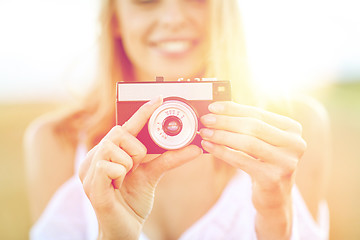 Image showing close up of woman photographing with film camera