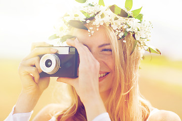 Image showing happy woman with film camera in wreath of flowers