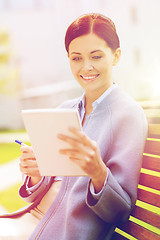 Image showing businesswoman reading notes in notepad outdoors