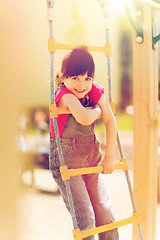 Image showing happy little girl climbing on children playground