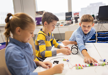 Image showing happy children building robots at robotics school