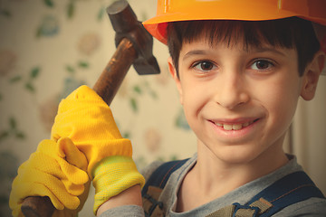 Image showing Boy in the image of a builder with a hammer in his hands