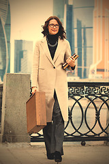 Image showing Smiling businesswoman in a light coat