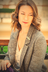 Image showing woman in gray jacket with dragonfly brooch