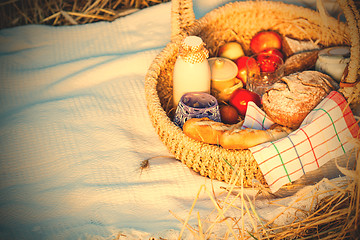 Image showing Bread, milk and apples in a basket.