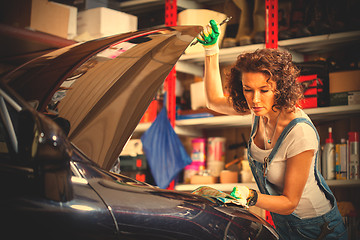Image showing beautiful woman in the jumpsuit of an auto mechanic