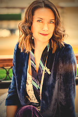 Image showing woman in purple jacket with dragonfly brooch