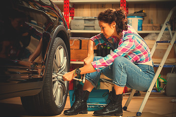 Image showing woman car mechanic in blue jeans jumpsuit