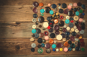 Image showing Old buttons on the wooden boards