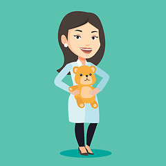 Image showing Pediatrician doctor holding teddy bear.