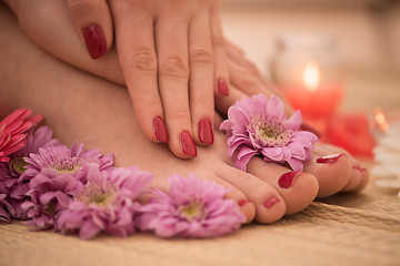 Image showing female feet and hands at spa salon