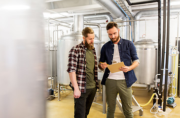 Image showing men with clipboard at craft brewery or beer plant