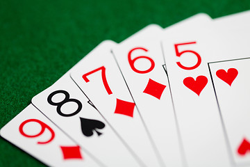 Image showing poker hand of playing cards on green casino cloth