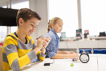 Image showing happy children building robots at robotics school