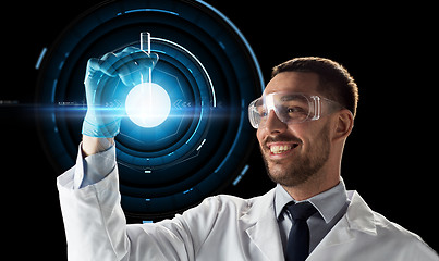 Image showing smiling scientist in goggles with test tube