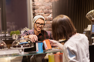 Image showing happy woman buying chai latte drink at vegan cafe