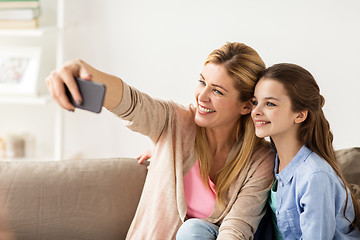 Image showing happy family taking selfie by smartphone at home