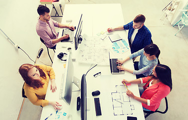 Image showing creative team with computers, blueprint at office