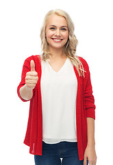 Image showing happy smiling young woman showing thumbs up