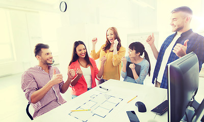 Image showing happy creative team celebrating success at office