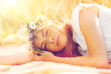 Image showing happy woman in wreath of flowers on cereal field