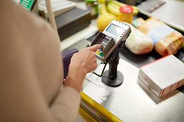 Image showing woman entering pin code at store cash register