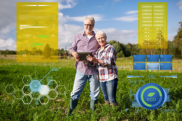 Image showing happy senior couple with tablet pc at summer farm