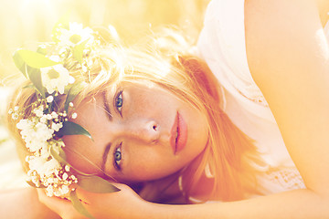 Image showing happy woman in wreath of flowers on cereal field