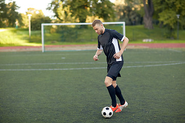 Image showing soccer player playing with ball on football field