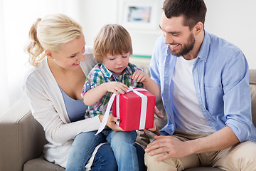 Image showing happy family with birthday gift at home