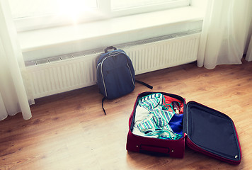 Image showing close up of travel bag with clothes and backpack