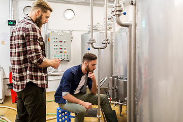 Image showing men with tablet pc at craft beer brewery kettle