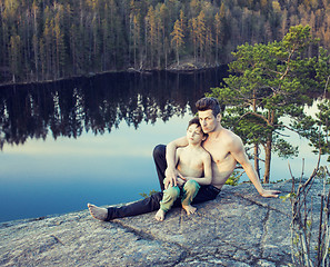 Image showing middle age man with little cute son doing sport yoga on the top of the mountain together, happy family lifestyle people outdoor, summer wild nature for training 