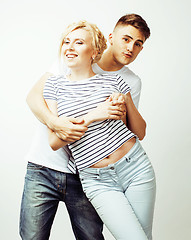 Image showing young pretty teenage couple, hipster guy with his girlfriend happy smiling and hugging isolated on white background, lifestyle people concept