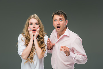 Image showing Portrait of a young couple standing against gray background