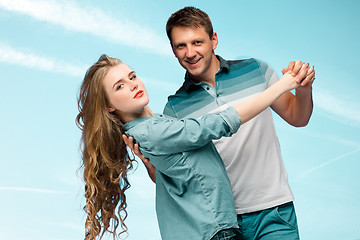 Image showing Young couple smiling under blue sky