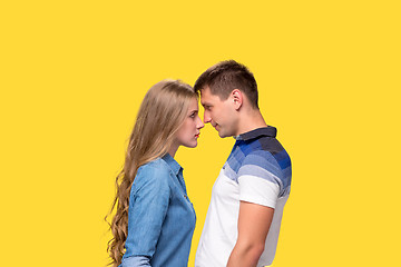 Image showing Portrait of a young couple standing against gray background