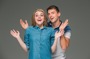 Image showing Portrait of a young couple standing against gray background