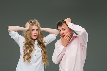 Image showing Portrait of a young couple standing against gray background