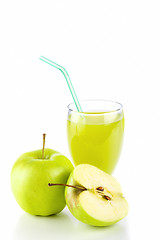 Image showing Apple juice in glass and green apples