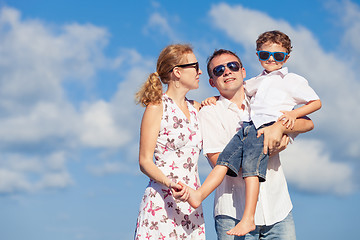 Image showing Happy family walking on the beach at the day time.