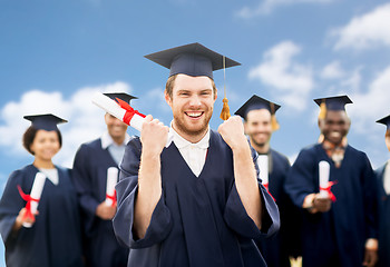 Image showing happy student with diploma celebrating graduation