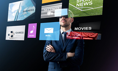 Image showing businessman in virtual reality headset over black