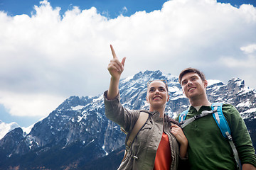 Image showing happy couple with backpacks traveling in highlands