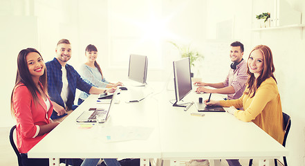 Image showing creative team with computers, blueprint at office