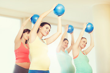 Image showing happy pregnant women exercising with ball in gym