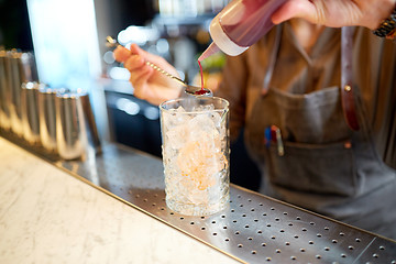 Image showing bartender with cocktail stirrer and glass at bar